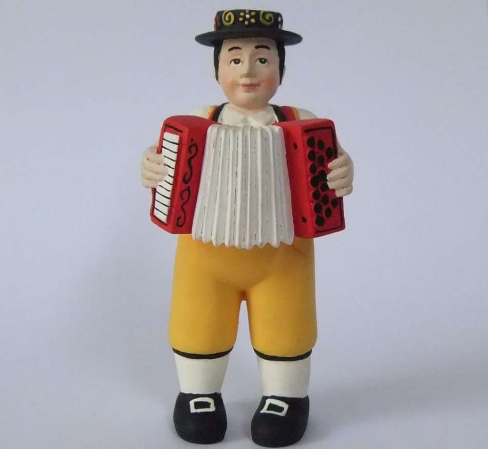 A STUNNING HAND MADE HAND PAINTED VINTAGE MUSICIAN FIGURE PLAYING THE ACCORDIAN FROM SWITZERLAND !!