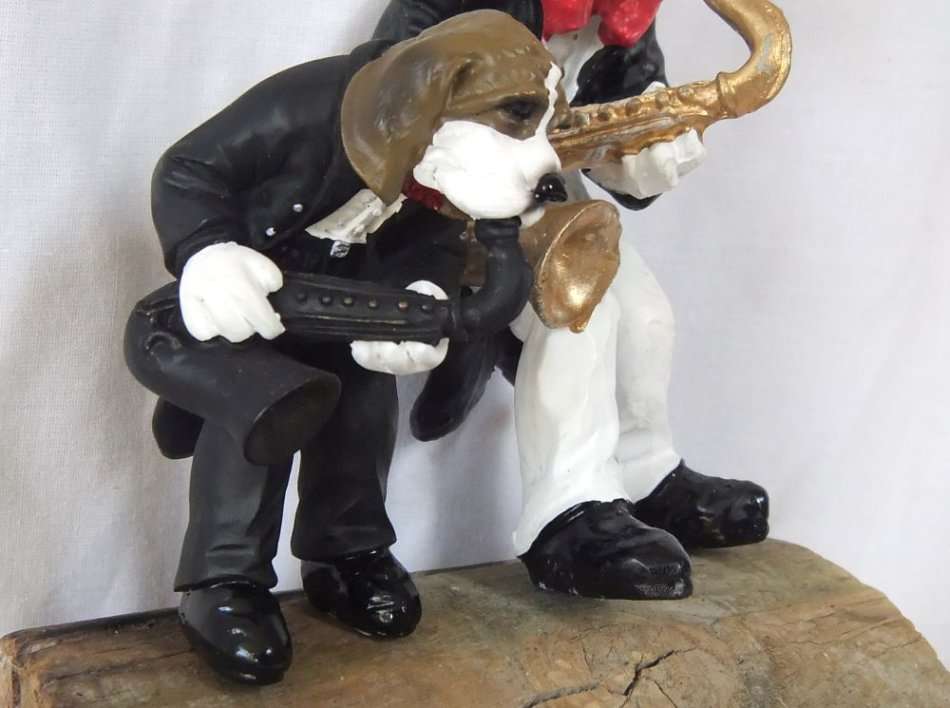 AN UNLIKELY COUPLE !! TWO DETAILED RESIN COMPOSITE FIGURES OF MUSICIANS PLAYING THE SAXOPHONE !!