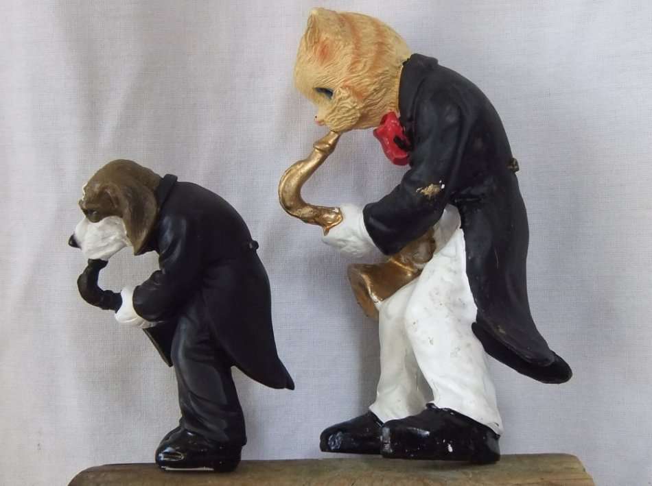 AN UNLIKELY COUPLE !! TWO DETAILED RESIN COMPOSITE FIGURES OF MUSICIANS PLAYING THE SAXOPHONE !!