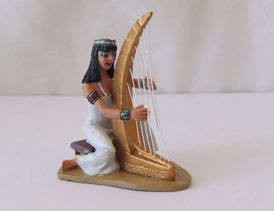 A GORGEOUS HAND PAINTED SOLID LEAD MODEL OF AN EGYPTIAN GODDESS PLAYING THE HARP BY KING & COUNTRY`S