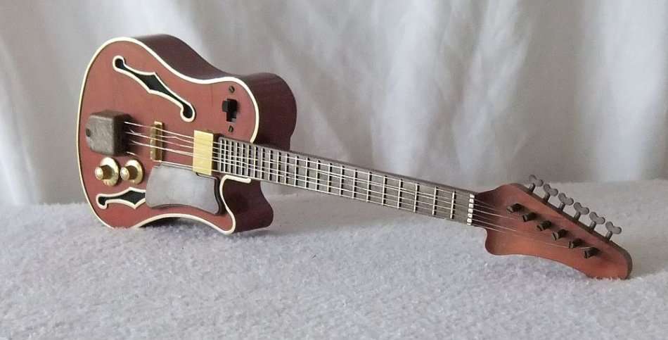 NOT JUST A INTRICATELY DETAILED MODEL OF AN ELECTRIC GUITAR !! ALSO A WORKING RADIO !! OH MY SOUL !!