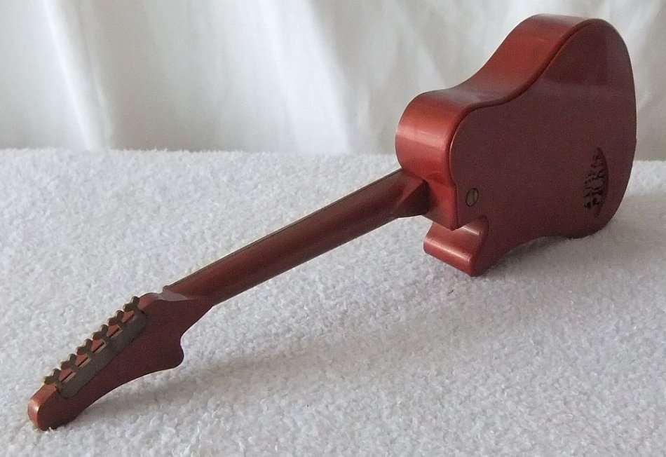 NOT JUST A INTRICATELY DETAILED MODEL OF AN ELECTRIC GUITAR !! ALSO A WORKING RADIO !! OH MY SOUL !!