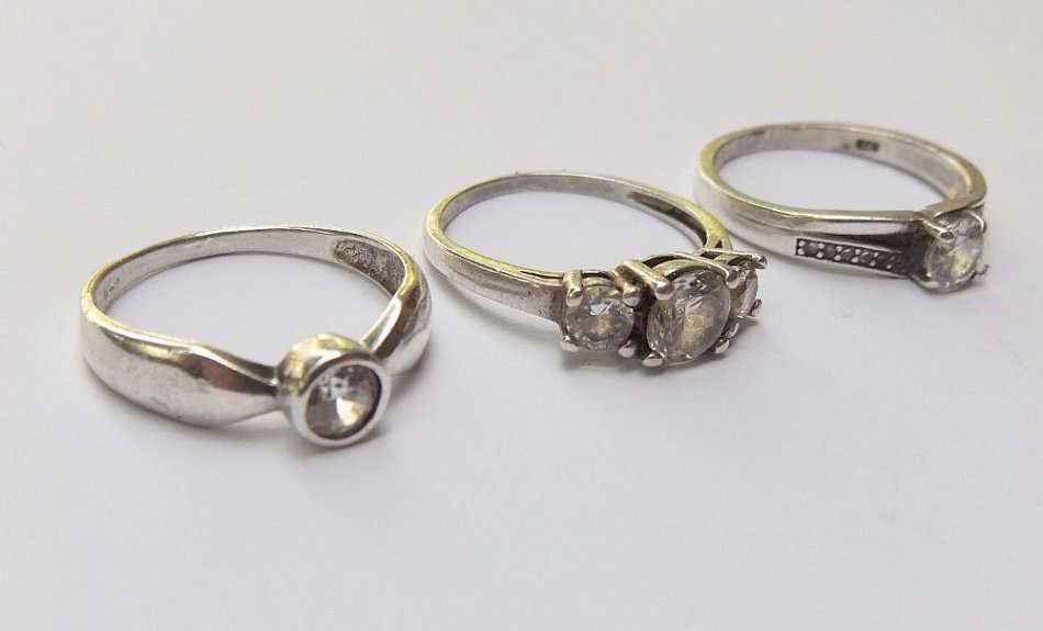 THREE ABSOLUTELY GORGEOUS SOLID STERLING SILVER RINGS SET WITH CUBIC ZIRCONIAS !! BID FOR THE LOT !!