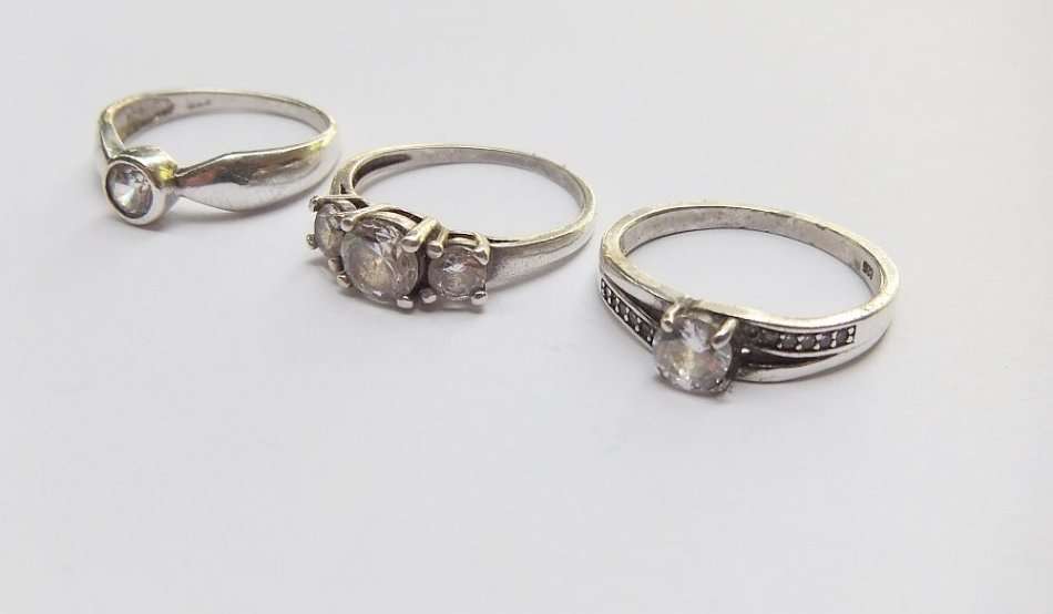 THREE ABSOLUTELY GORGEOUS SOLID STERLING SILVER RINGS SET WITH CUBIC ZIRCONIAS !! BID FOR THE LOT !!