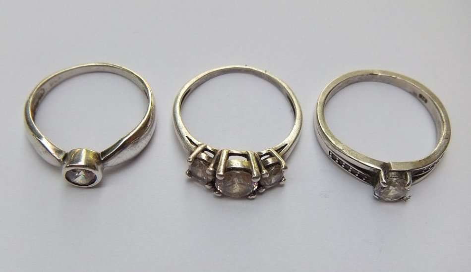 THREE ABSOLUTELY GORGEOUS SOLID STERLING SILVER RINGS SET WITH CUBIC ZIRCONIAS !! BID FOR THE LOT !!