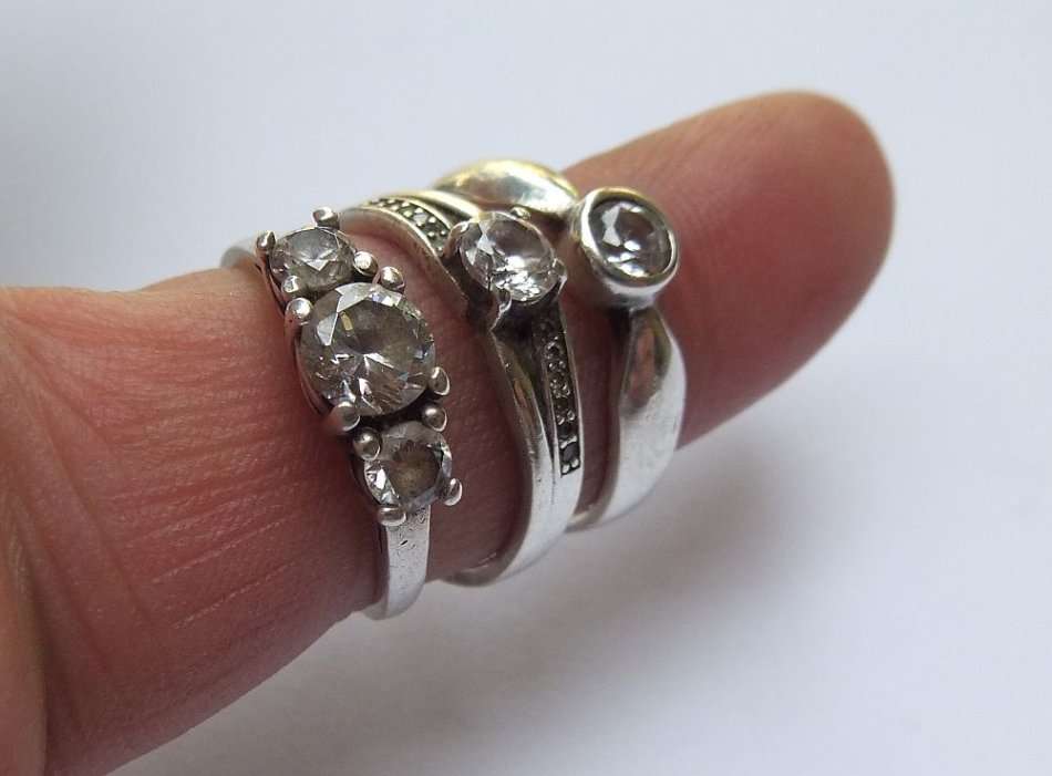 THREE ABSOLUTELY GORGEOUS SOLID STERLING SILVER RINGS SET WITH CUBIC ZIRCONIAS !! BID FOR THE LOT !!