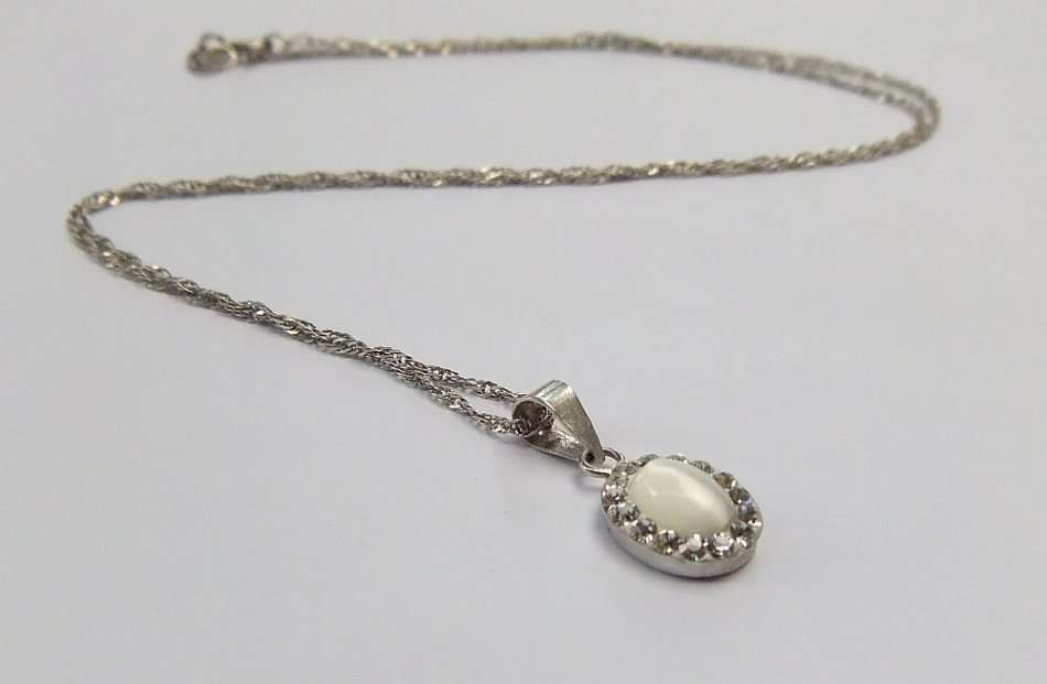 A LOVELY STERLING SILVER PENDANT SET WITH FASCINATING ADORNMENTS PLUS A STERLING SILVER NECKLACE !!