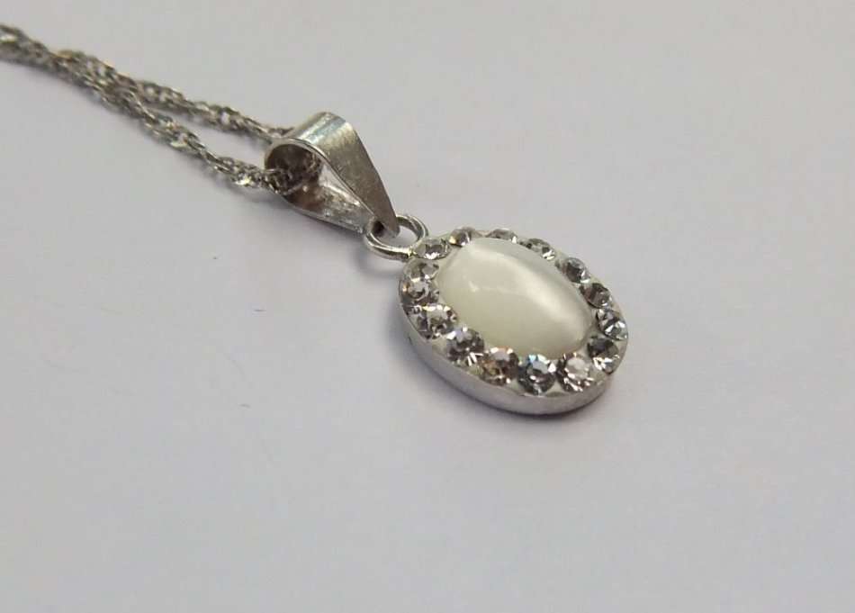A LOVELY STERLING SILVER PENDANT SET WITH FASCINATING ADORNMENTS PLUS A STERLING SILVER NECKLACE !!