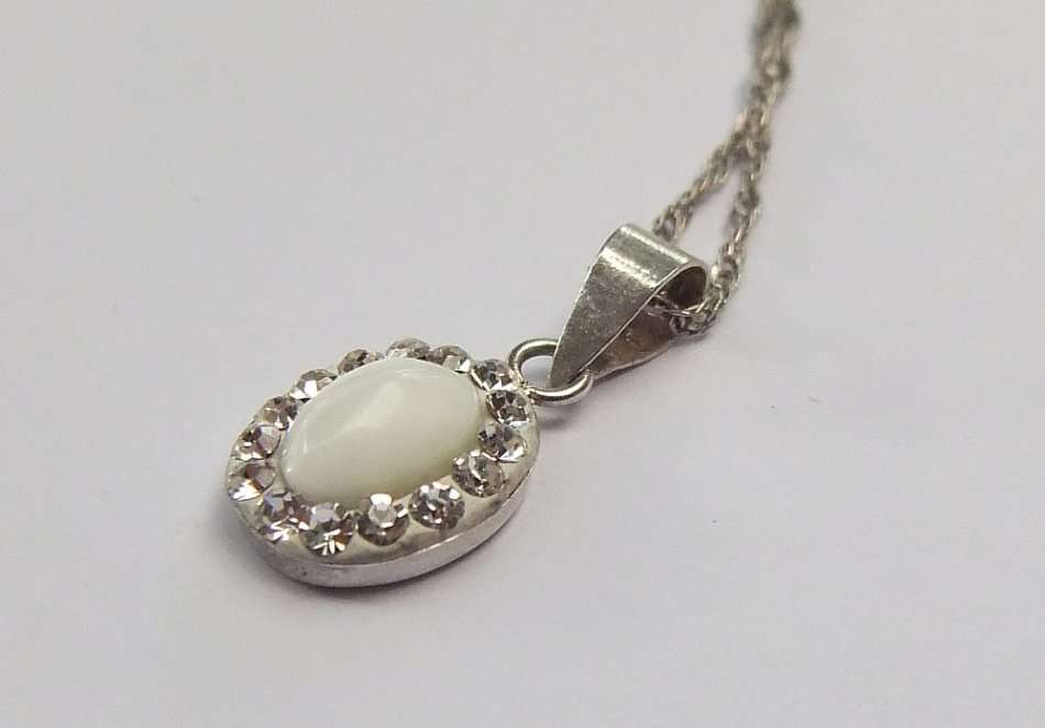 A LOVELY STERLING SILVER PENDANT SET WITH FASCINATING ADORNMENTS PLUS A STERLING SILVER NECKLACE !!
