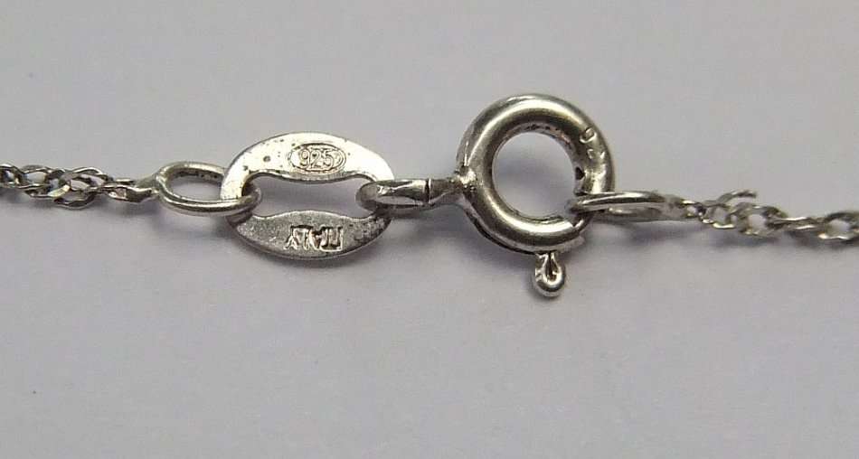 A LOVELY STERLING SILVER PENDANT SET WITH FASCINATING ADORNMENTS PLUS A STERLING SILVER NECKLACE !!