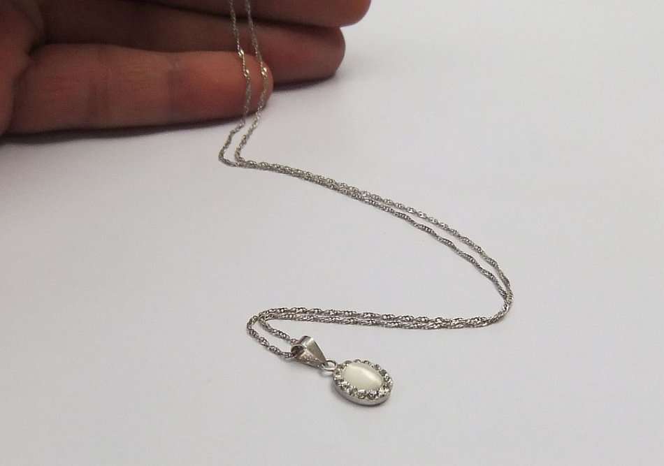 A LOVELY STERLING SILVER PENDANT SET WITH FASCINATING ADORNMENTS PLUS A STERLING SILVER NECKLACE !!