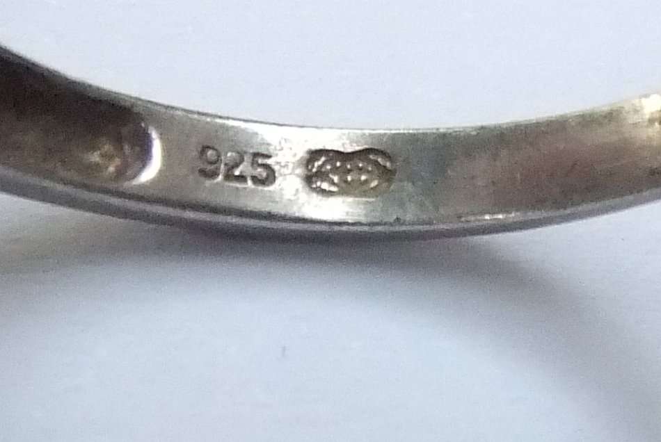 A SOLID STERLING SILVER DESIGNER STAMPED RING WITH FACETED PALE BLUE STONE - STAMPED AND TESTED