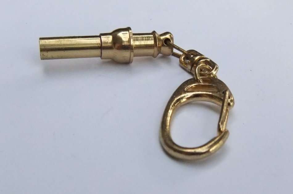 A VINTAGE METAL WHISTLE KEYRING