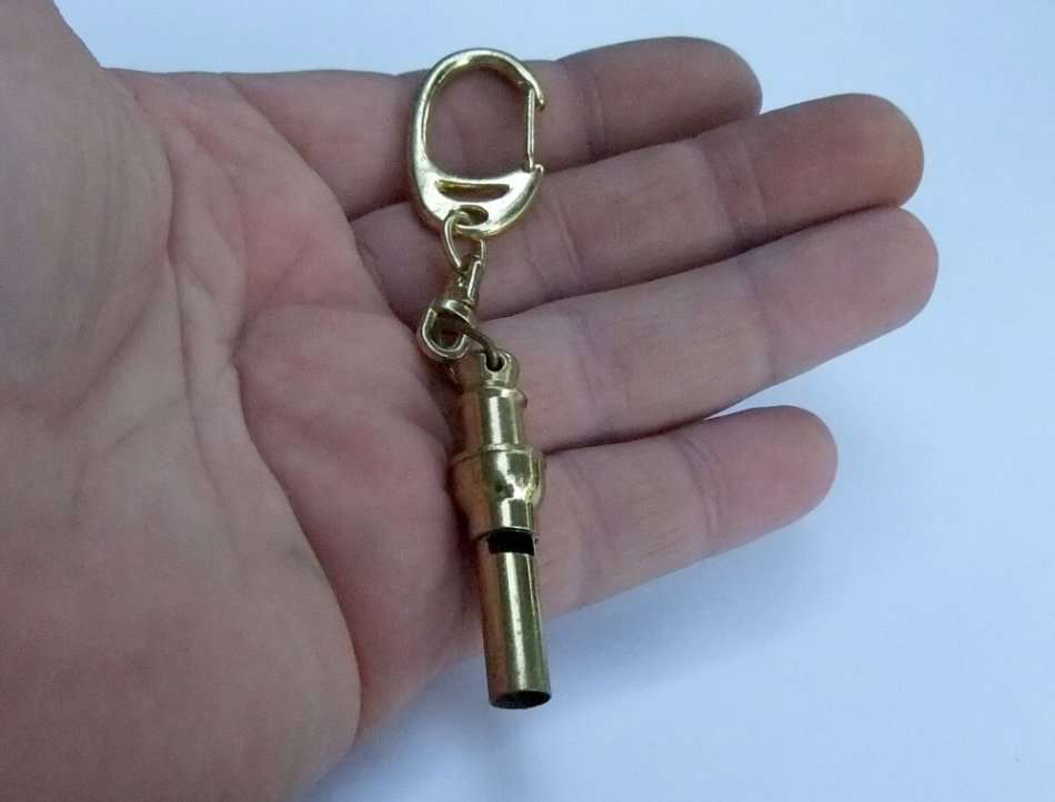 A VINTAGE METAL WHISTLE KEYRING