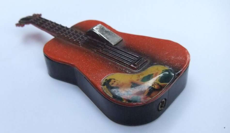 A VINTAGE GUITAR FORM METAL ELECTRICAL LIGHTER - NO GAS BUT SPARKS