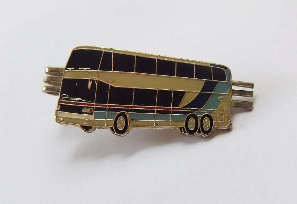 A VINTAGE TIE CLIP WITH TOUR BUS MOTIF