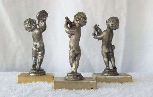 LOOK !! AN ADORABLE SET OF THREE PEWTER TYPE METAL CHERUBS ON METAL PLINTHS !! MUSICAL VIBES !!
