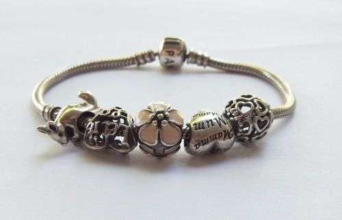 WOW ! OVER R3000 VALUE !! A GENUINE PANDORA SOLID STERLING SILVER CHARM BRACELET WITH FIVE CHARMS !!