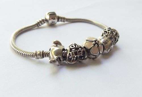 WOW ! OVER R3000 VALUE !! A GENUINE PANDORA SOLID STERLING SILVER CHARM BRACELET WITH FIVE CHARMS !!