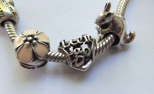 WOW ! OVER R3000 VALUE !! A GENUINE PANDORA SOLID STERLING SILVER CHARM BRACELET WITH FIVE CHARMS !!