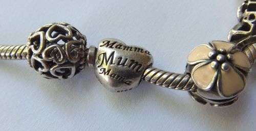 WOW ! OVER R3000 VALUE !! A GENUINE PANDORA SOLID STERLING SILVER CHARM BRACELET WITH FIVE CHARMS !!