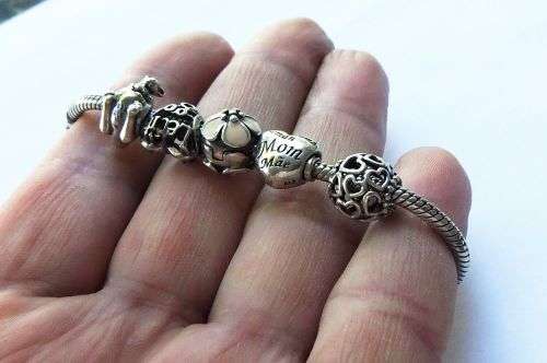 WOW ! OVER R3000 VALUE !! A GENUINE PANDORA SOLID STERLING SILVER CHARM BRACELET WITH FIVE CHARMS !!