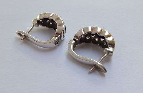 A QUALITY HIGH CLASS SOLID STERLING SILVER HINGED PAIR OF EARRINGS SET WITH DARK AND CLEAR STONES !!