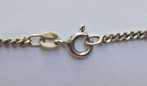 A COOL SOLID STERLING SILVER AFRICA PENDANT SET WITH A FACETED STONE PLUS A STERLING SILVER NECKLACE