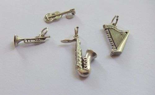 A DELIGHTFUL LOT OF 4 SOLID STERLING SILVER MUSICAL INSTRUMENT CHARMS IN EXCELLENT CONDITION !! WOW