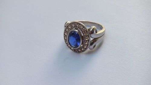 A GORGEOUS SOLID STERLING SILVER RING SET WITH A FACETED BLUE STONE AND CLEAR STONES !! MUST SEE !!