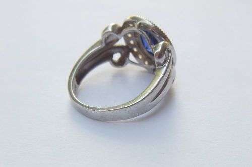 A GORGEOUS SOLID STERLING SILVER RING SET WITH A FACETED BLUE STONE AND CLEAR STONES !! MUST SEE !!