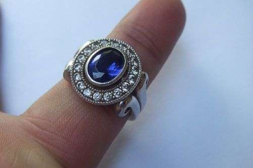 A GORGEOUS SOLID STERLING SILVER RING SET WITH A FACETED BLUE STONE AND CLEAR STONES !! MUST SEE !!