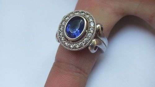 A GORGEOUS SOLID STERLING SILVER RING SET WITH A FACETED BLUE STONE AND CLEAR STONES !! MUST SEE !!