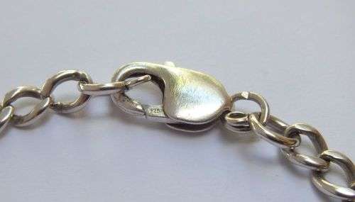 A STRONG VINTAGE  SOLID STERLING SILVER STARTER CHARM BRACELET WITH OVERSIZED CLASP !! WOW !!
