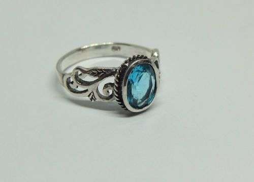 WOW ! A STUNNING SOLID STERLING SILVER RING SET WITH A FACETED LIGHT BLUE STONE !! LOTS OF CURVES !!