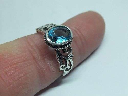 WOW ! A STUNNING SOLID STERLING SILVER RING SET WITH A FACETED LIGHT BLUE STONE !! LOTS OF CURVES !!