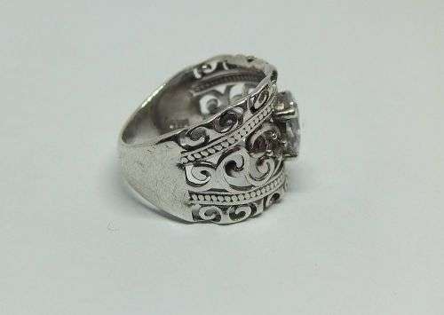 A CHARMING SOLID STERLING SILVER RING SET WITH A FACETED CLEAR STONE !! LOTS OF CURVEY DETAIL !!