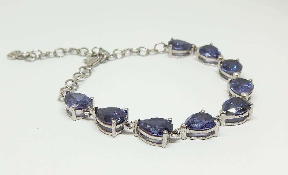 A MAGNIFICENT DESIGNER STERLING SILVER BRACELET SET WITH FACETED BLUEISH PEAR SHAPED STONES !! WOW !