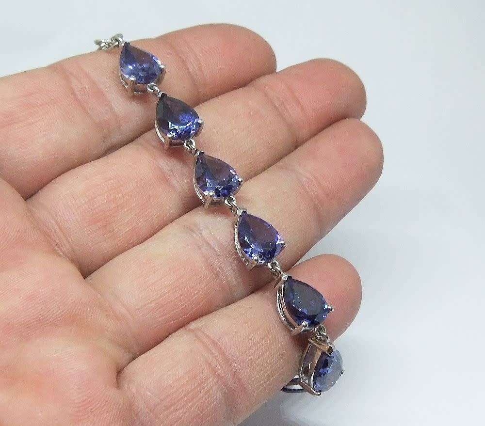 A MAGNIFICENT DESIGNER STERLING SILVER BRACELET SET WITH FACETED BLUEISH PEAR SHAPED STONES !! WOW !