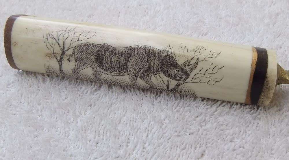 WOW !! AN AWESOME VINTAGE GENUINE BONE & WOOD HANDLE BOTTLE OPENER WITH RHINO ENGRAVING !!