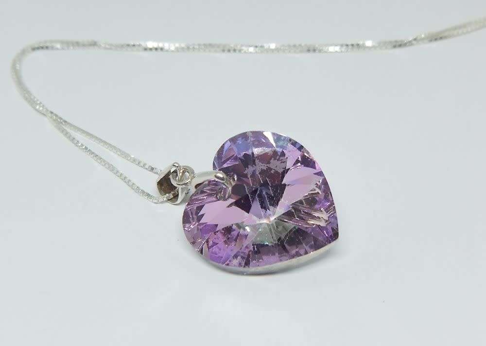 A genuine sterling silver necklace with a sterling silver mounted heart pendant - glass or crystal