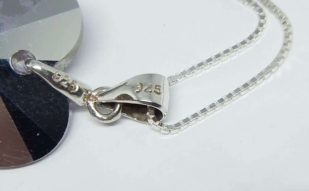 A genuine sterling silver necklace with a sterling silver mounted heart pendant - glass or crystal
