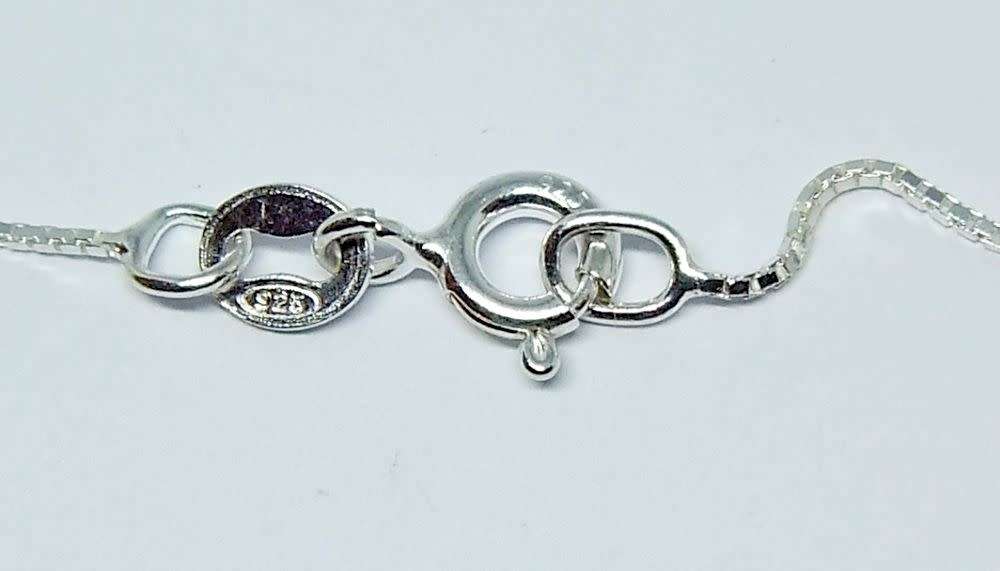 A genuine sterling silver necklace with a sterling silver mounted heart pendant - glass or crystal