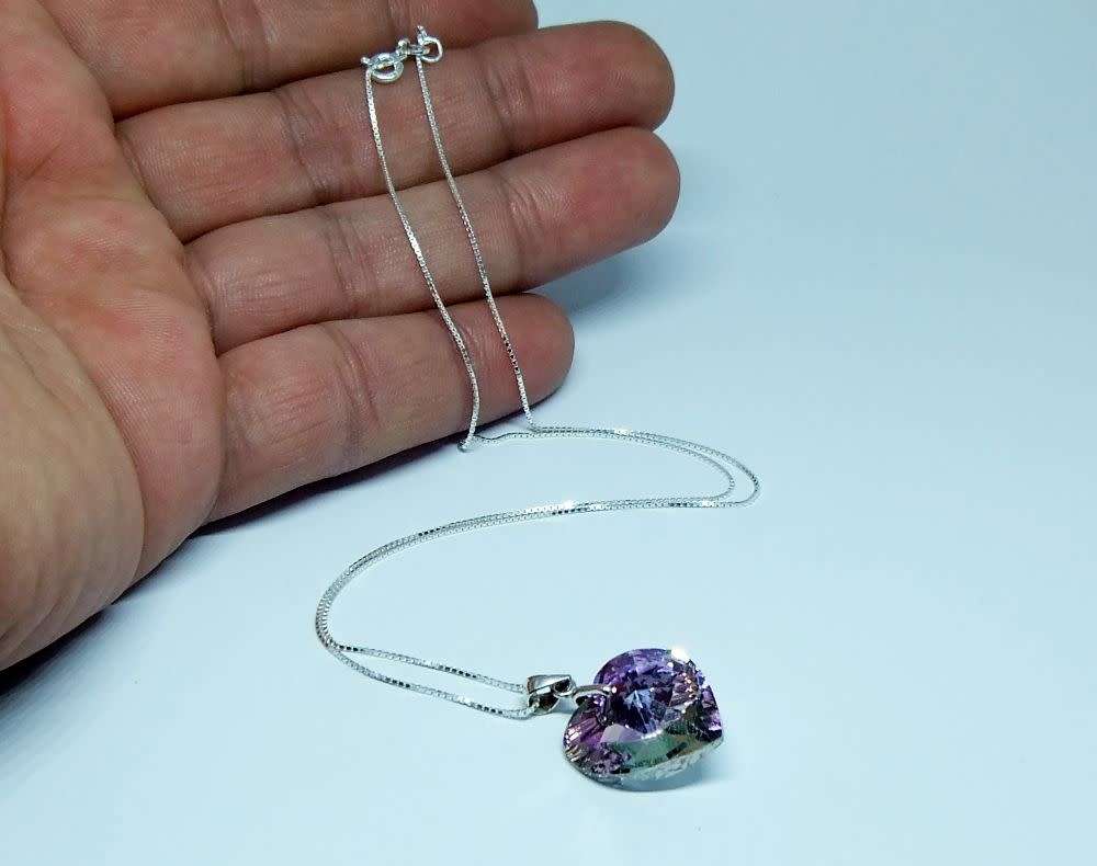 A genuine sterling silver necklace with a sterling silver mounted heart pendant - glass or crystal