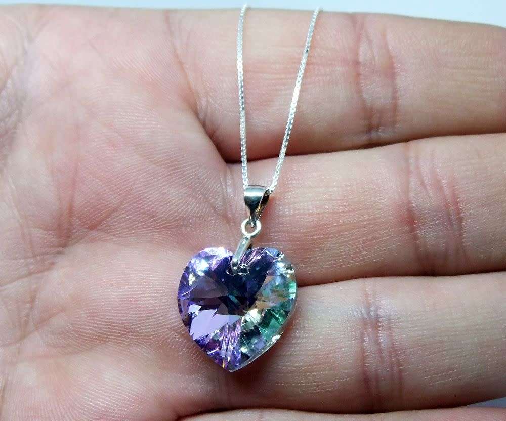 A genuine sterling silver necklace with a sterling silver mounted heart pendant - glass or crystal
