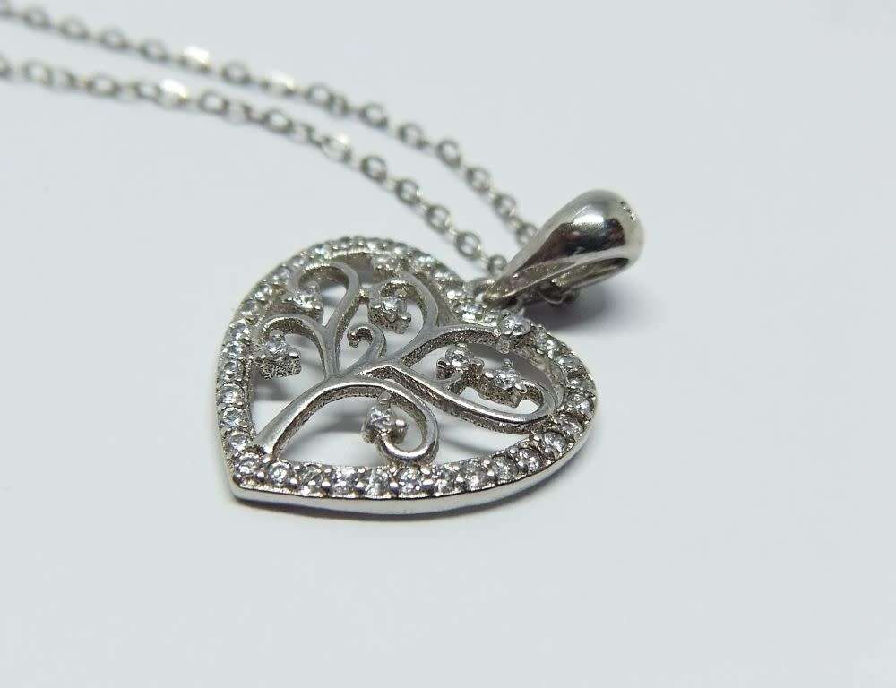 A genuine sterling silver necklace and heart pendant containing the tree of life with clear insets