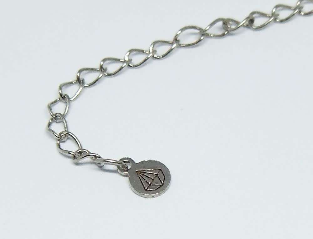 A genuine sterling silver necklace and heart pendant containing the tree of life with clear insets