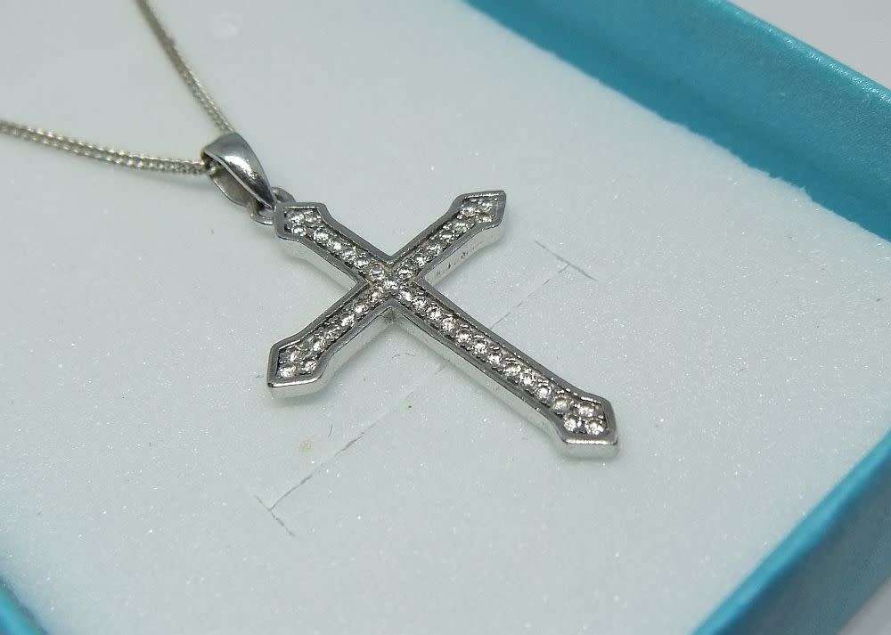 A genuine sterling silver necklace and cross pendant with faceted clear insets plus gift box