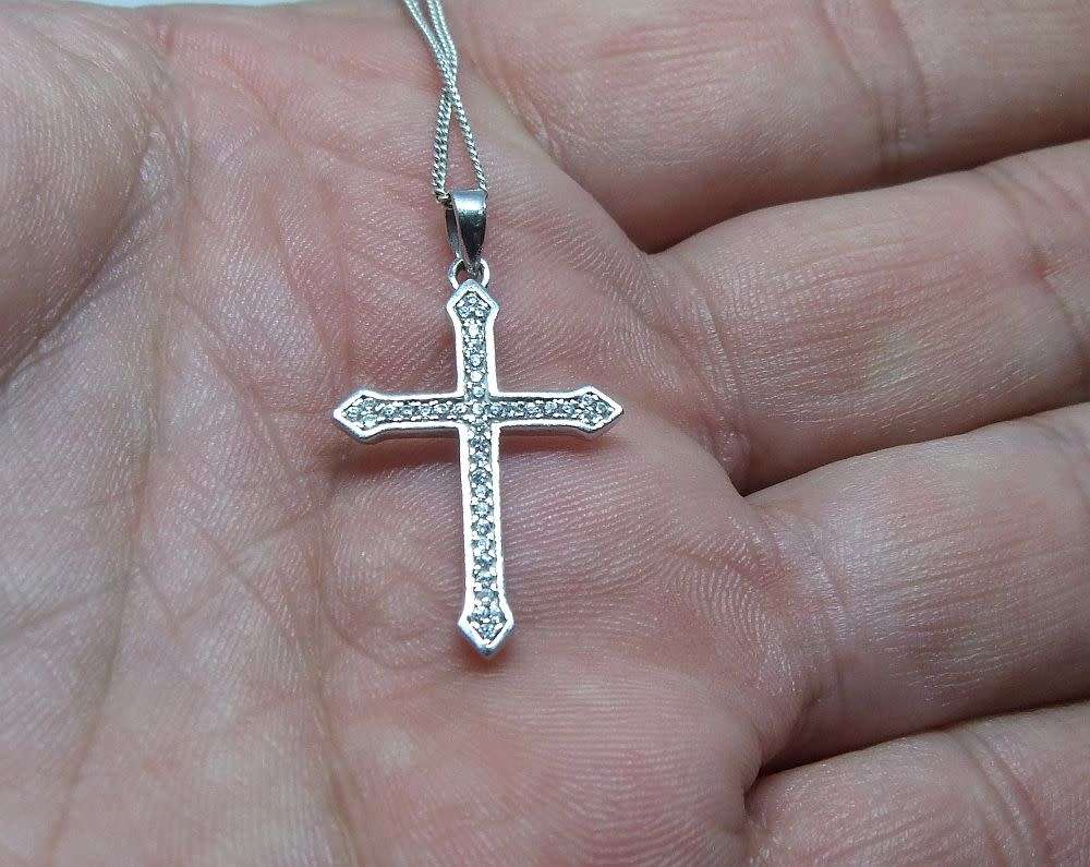A genuine sterling silver necklace and cross pendant with faceted clear insets plus gift box