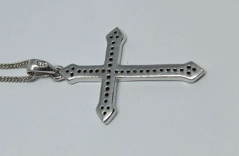 A genuine sterling silver necklace and cross pendant with faceted clear insets plus gift box